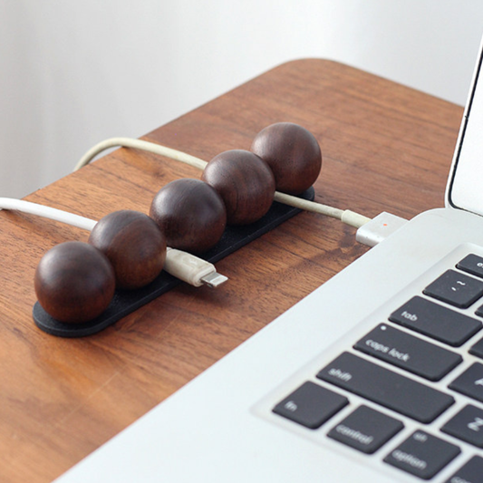 Magnetic walnut cable organizer keeping charging cords neat and accessible