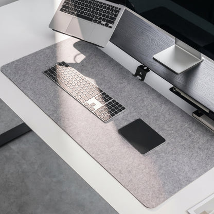 Minimal home office desk setup with NORVEN felt desk mat and keyboard