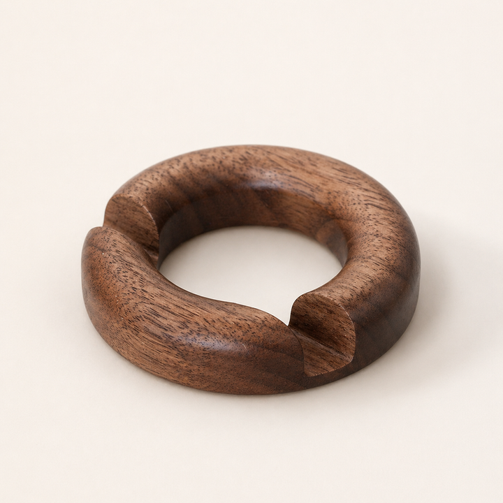 NORVEN round walnut phone stand on a warm minimalist desk